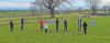 Group of teenagers in field doing archery